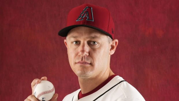 Paul Sewald poses for a photo, with a four-seam fastball grip, on Photo Day at Salt River Fields.